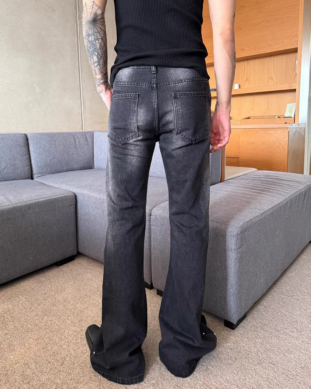 濃紺デニムのフレアパンツ。腰から裾まで、スタッズを配置した縦ラインが特徴。ストレートシルエットから裾にかけてやや広がり、バックポケットは標準的な切替。