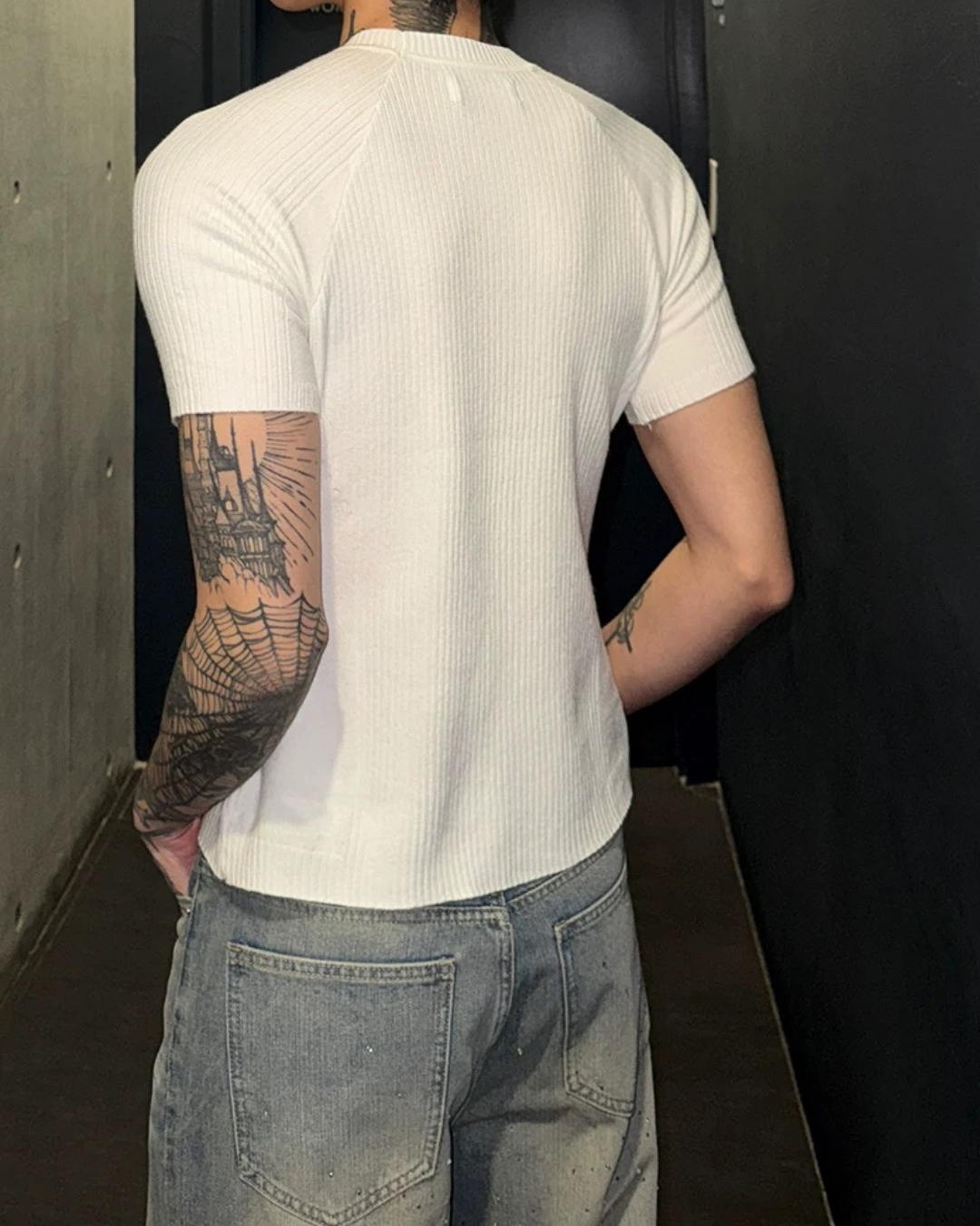 オフホワイトのリブニット素材半袖Tシャツ。タイトなシルエットで縦方向のリブ編み地が特徴。クルーネック。