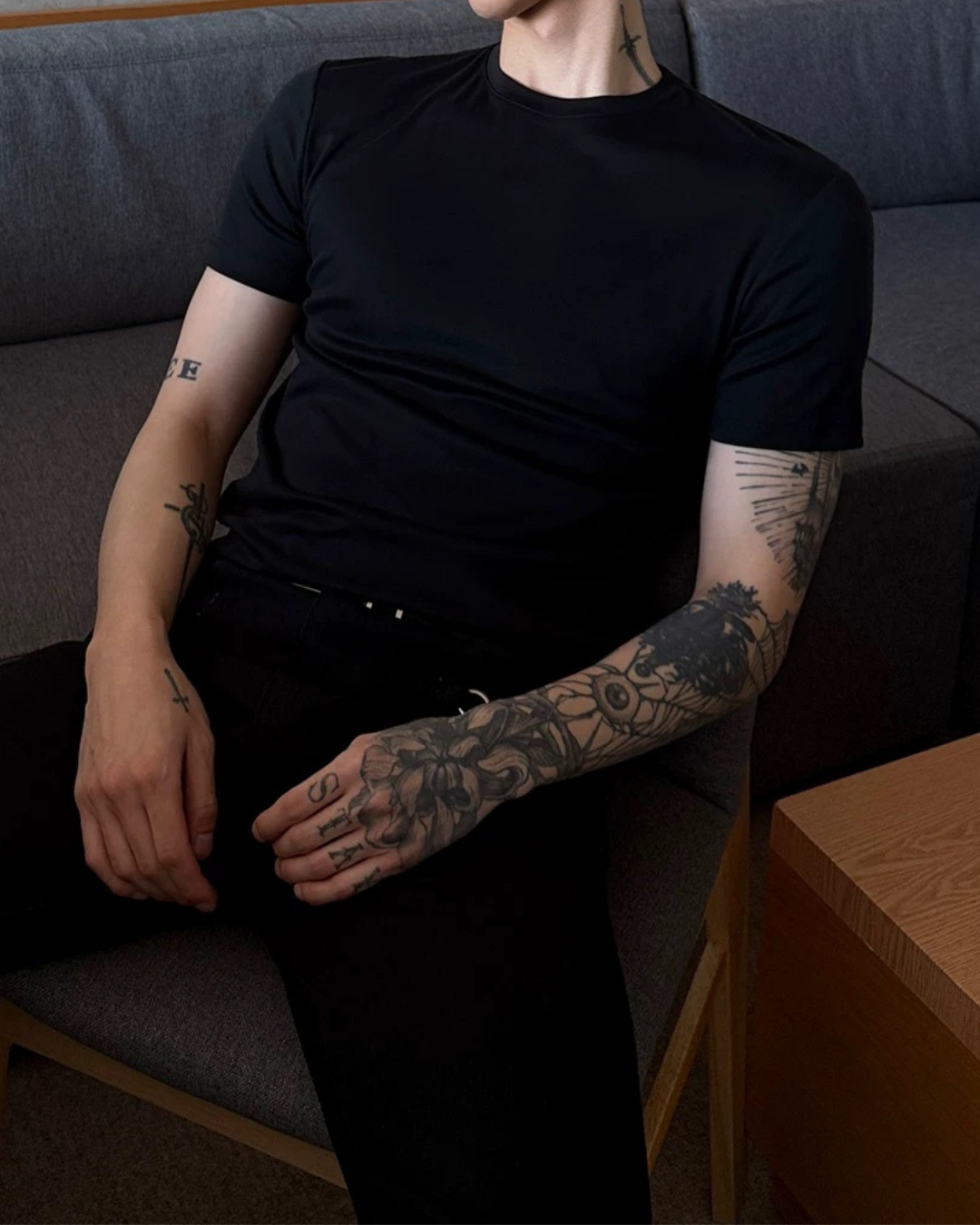 黒のクルーネックTシャツ。半袖でシンプルなシルエット、タイトフィット。胸から裾にかけてストレートな構造。