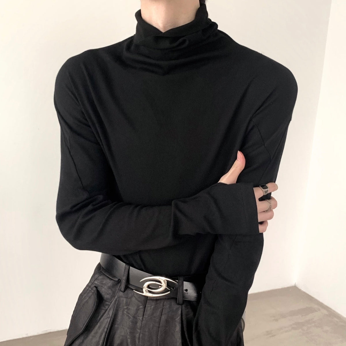 メンズの黒のリブ編みカットソー。タートルネック、長袖で身体に沿うタイトシルエット。